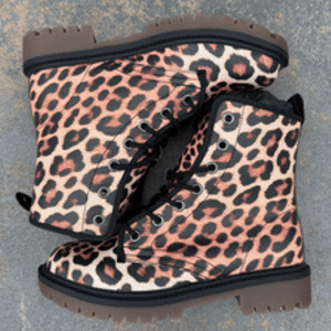 Leopard Print Unisex Lace Up Combat Ankle Boots by Love Hype and Glory arranged on outdoor terrace tiles