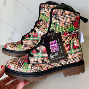 Hand holding a pair of Patchwork Plaid Tartan Unisex Combat Ankle Boots by Love Hype and Glory