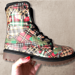 Hand with red nails holding a single Patchwork Plaid Tartan Unisex Combat Ankle Boot by Love Hype and Glory
