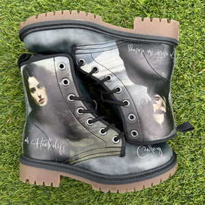 Pair of Bronte Wuthering Heights mismatched Cathy and Heathcliff boots on a grass background