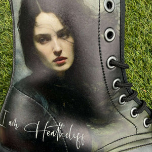 Mismatched Bronte Wuthering Heights boot with a printed design of Cathy's face and 'I am Heathcliff' text on grass.