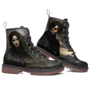 Mismatched Bronte Wuthering Heights boots with Cathy and Heathcliff printed faces and names on a white background